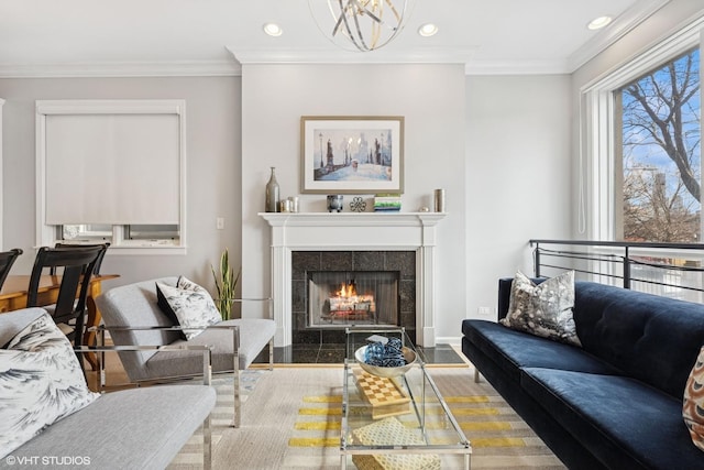 living area featuring ornamental molding, recessed lighting, baseboards, and a tile fireplace