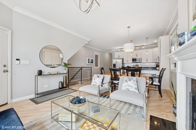 living area with light wood-style flooring, baseboards, and ornamental molding