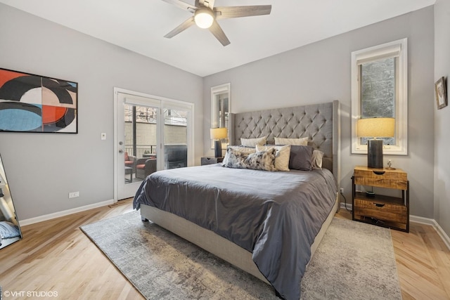 bedroom featuring baseboards, light wood-style floors, a ceiling fan, and access to outside