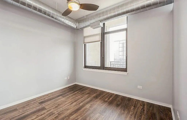 spare room with ceiling fan, baseboards, and wood finished floors