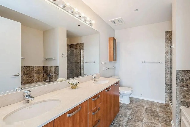 full bathroom with toilet, a shower stall, visible vents, and a sink