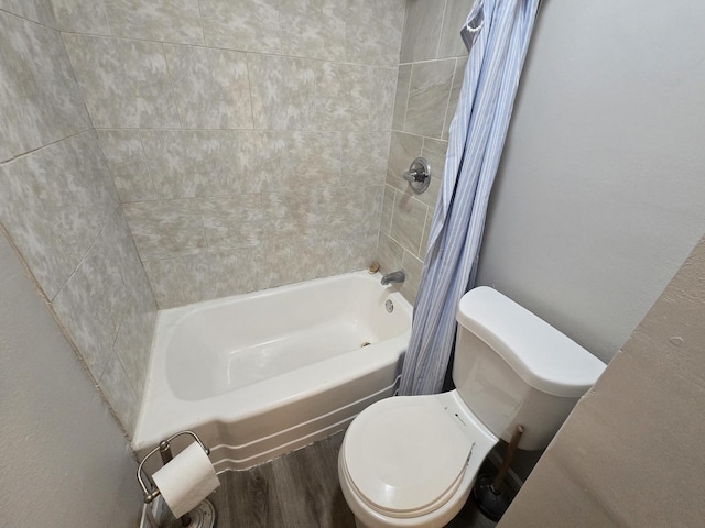 bathroom featuring toilet, shower / tub combo, and wood finished floors