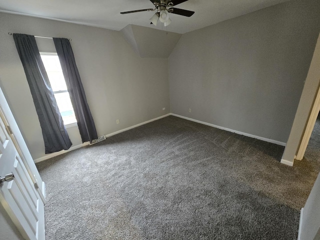 unfurnished bedroom with vaulted ceiling, carpet floors, ceiling fan, and baseboards