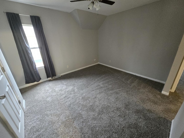 unfurnished bedroom featuring vaulted ceiling, carpet, a ceiling fan, and baseboards