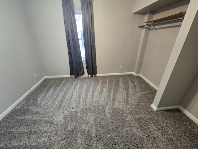 interior space with carpet floors and baseboards