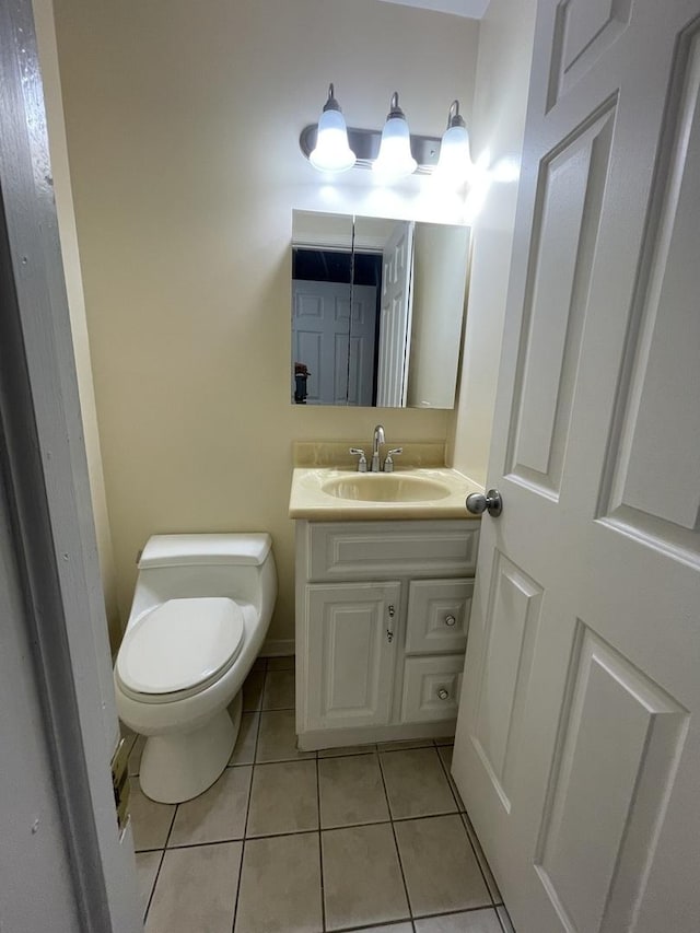 bathroom with vanity, toilet, and tile patterned floors