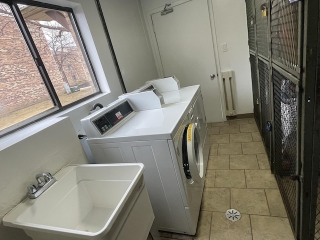 laundry area with a sink and independent washer and dryer