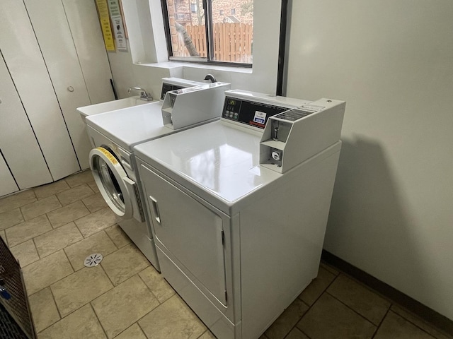 community laundry room featuring a sink and washer and clothes dryer