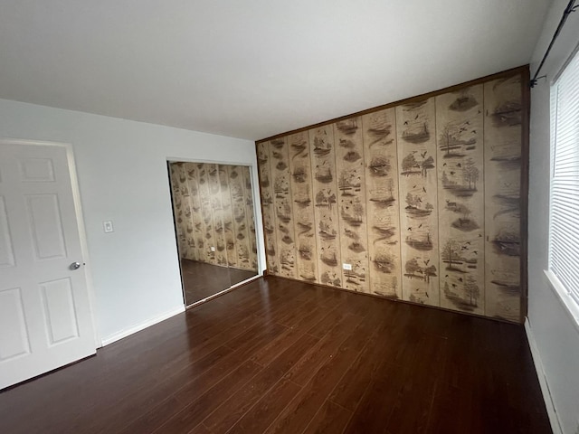 empty room featuring baseboards and wood finished floors