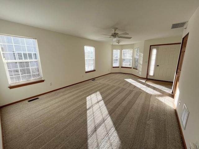 interior space with light colored carpet, visible vents, and baseboards