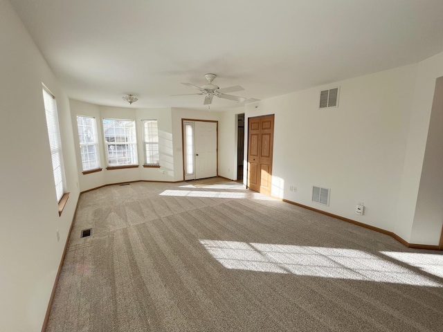 unfurnished living room featuring light carpet, baseboards, and visible vents