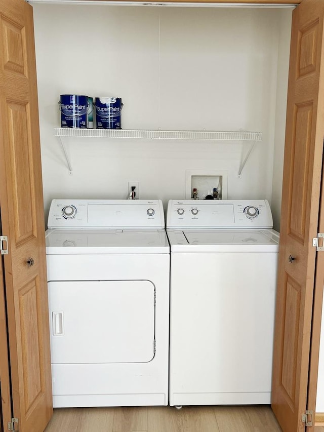 clothes washing area with laundry area and washer and clothes dryer