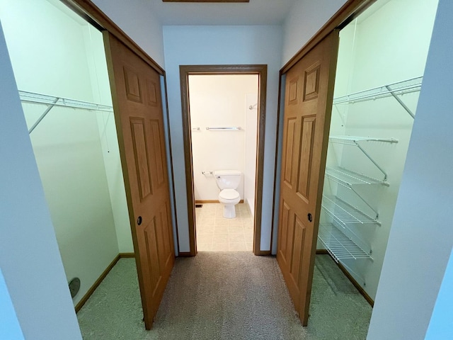 corridor featuring carpet floors and baseboards