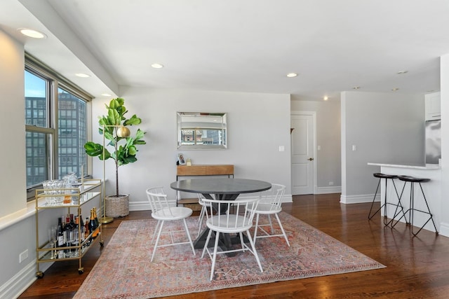 dining area featuring recessed lighting, baseboards, and wood finished floors