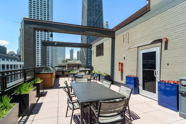 view of patio featuring outdoor dining space and a city view