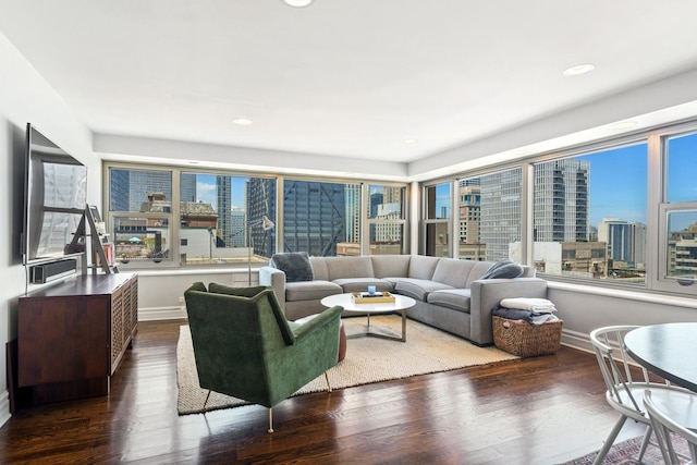 living area with a view of city, baseboards, dark wood-style floors, and recessed lighting