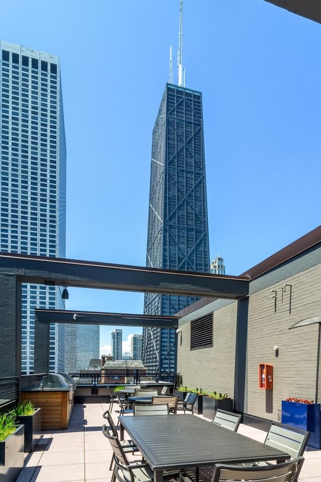 view of patio / terrace with a city view and outdoor dining space