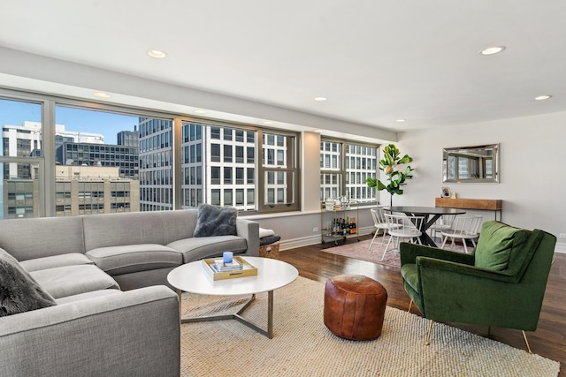 living area featuring plenty of natural light, a view of city, wood finished floors, and recessed lighting