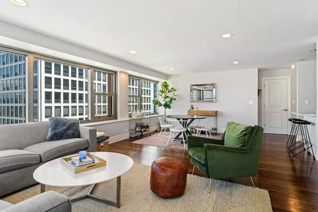 living room featuring recessed lighting, baseboards, and wood finished floors