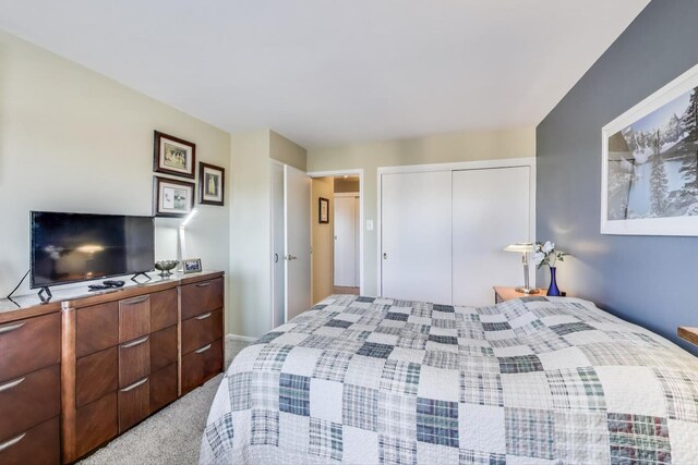 bedroom with light colored carpet and a closet