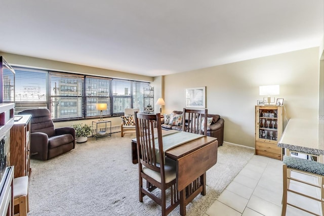 dining space featuring light tile patterned flooring and light colored carpet