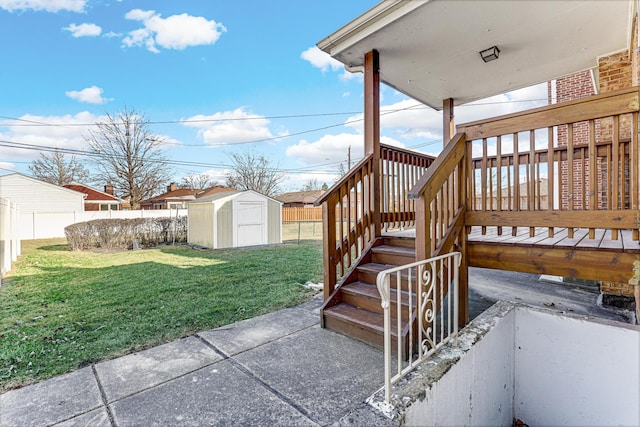 view of yard featuring an outbuilding, stairway, fence private yard, and a storage shed