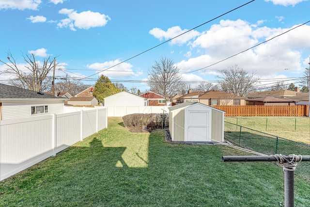 view of yard with a storage unit, a fenced backyard, a residential view, and an outdoor structure