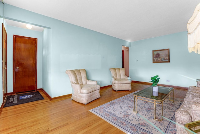 living room with baseboards and wood finished floors