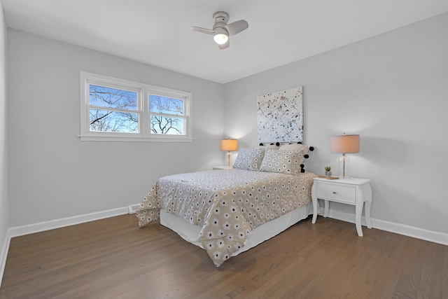 bedroom featuring a ceiling fan, baseboards, and wood finished floors