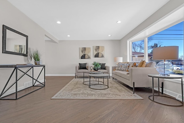 living room with baseboards, wood finished floors, and recessed lighting