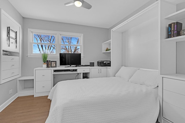 bedroom with baseboards, a ceiling fan, and wood finished floors