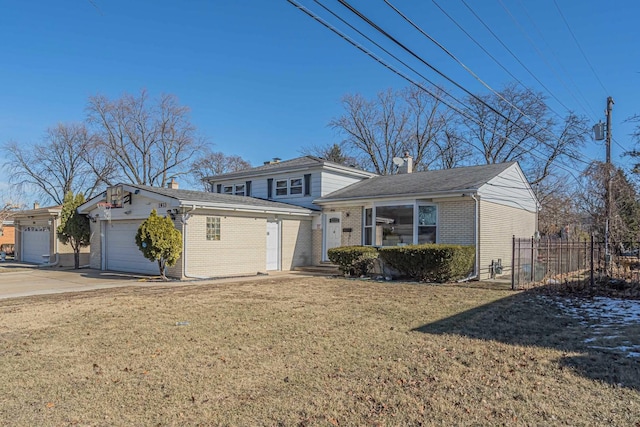 view of front of house featuring brick siding, concrete driveway, an attached garage, a front yard, and fence