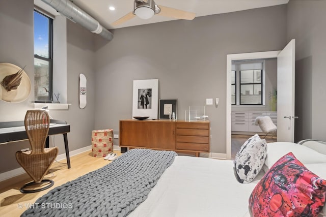 bedroom with baseboards and wood finished floors