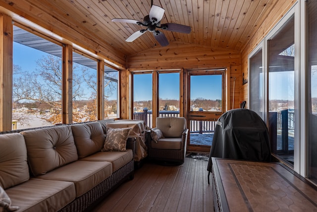 sunroom featuring lofted ceiling, wood ceiling, and ceiling fan