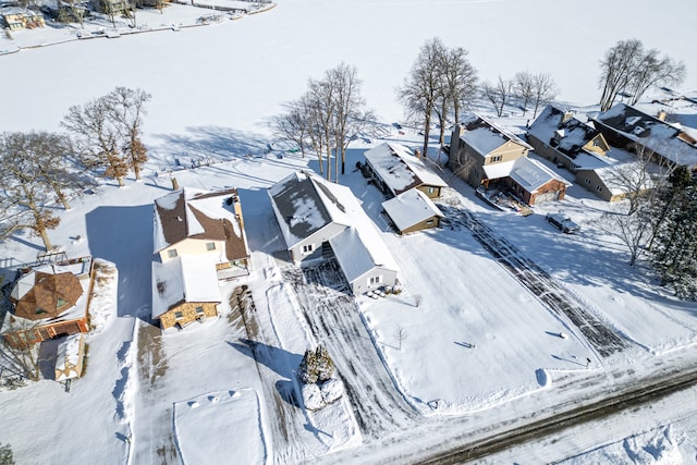 snowy aerial view with a residential view