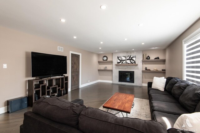 living area featuring visible vents, recessed lighting, a fireplace, and dark wood-type flooring