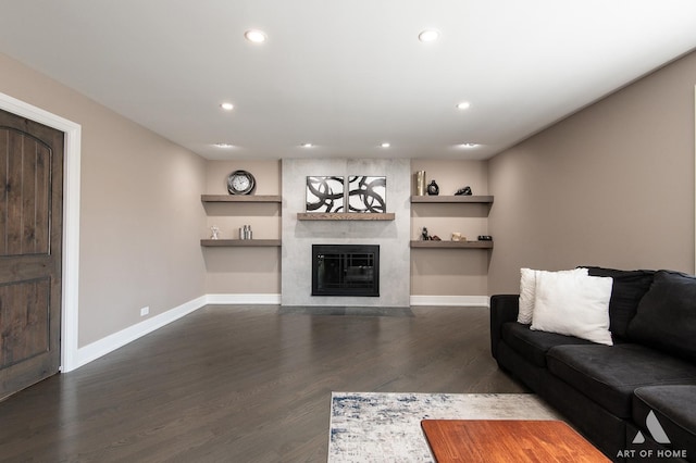 unfurnished living room with a fireplace, recessed lighting, wood finished floors, and baseboards