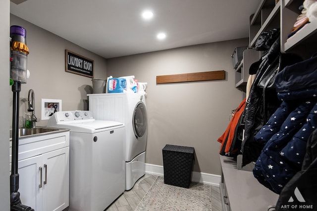 laundry room with baseboards, laundry area, recessed lighting, separate washer and dryer, and a sink