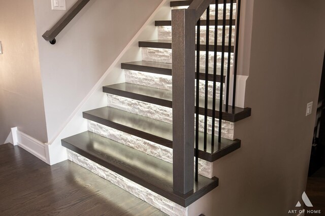 stairs featuring wood finished floors