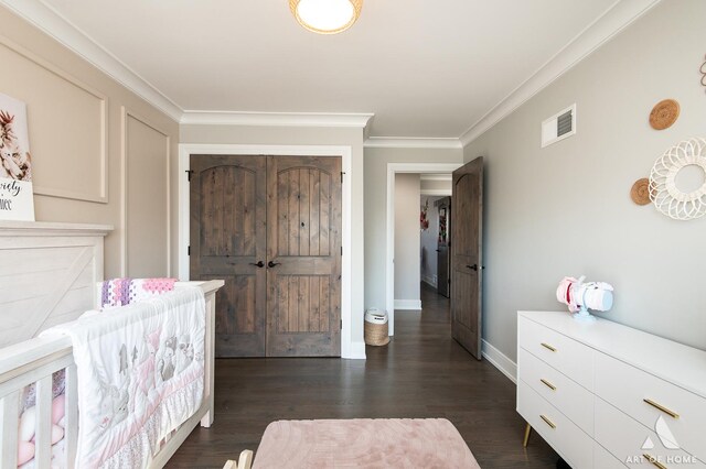 bedroom with visible vents, baseboards, dark wood-style flooring, and ornamental molding