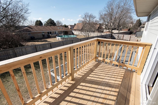 wooden terrace with a fenced backyard and a residential view