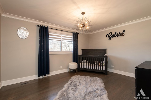 bedroom featuring baseboards, wood finished floors, visible vents, and ornamental molding