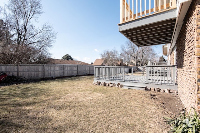 view of yard featuring a wooden deck and fence