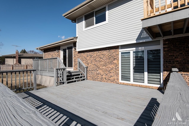 wooden terrace featuring fence