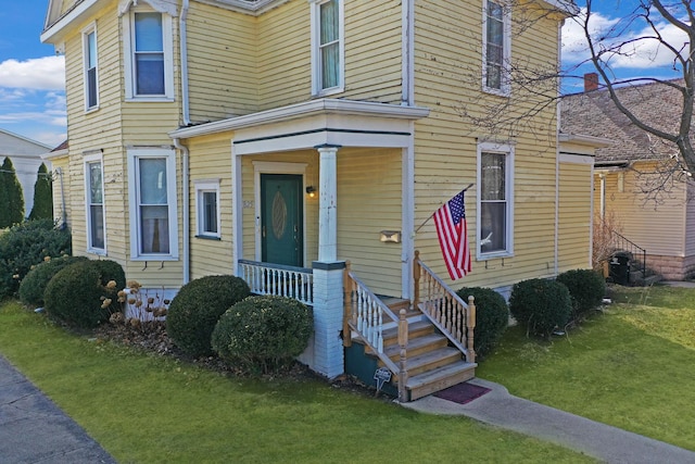 view of front of house featuring a front yard and covered porch