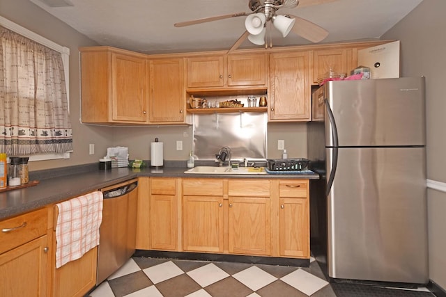 kitchen with dishwashing machine, freestanding refrigerator, ceiling fan, a sink, and tile patterned floors