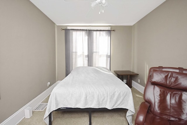 carpeted bedroom with ceiling fan and baseboards