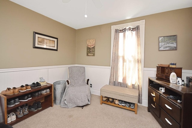 living area with carpet flooring and wainscoting