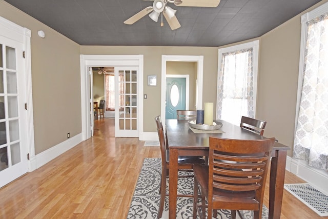 dining area featuring visible vents, baseboards, light wood-type flooring, and ceiling fan