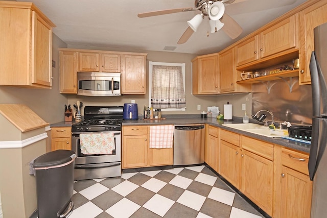 kitchen featuring a sink, tile patterned floors, light brown cabinetry, and stainless steel appliances